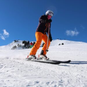 An image of someone wearing ski gear while skiing in Scotland on a sunny day.